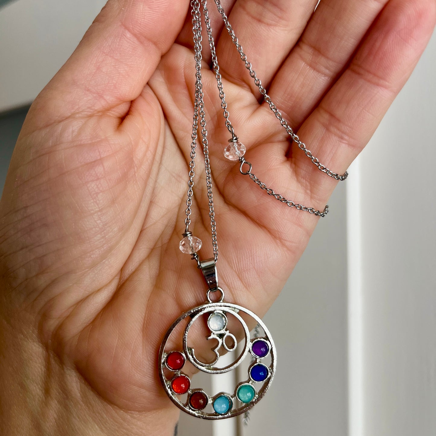 OM pendant on 26 inch stainless steel chain